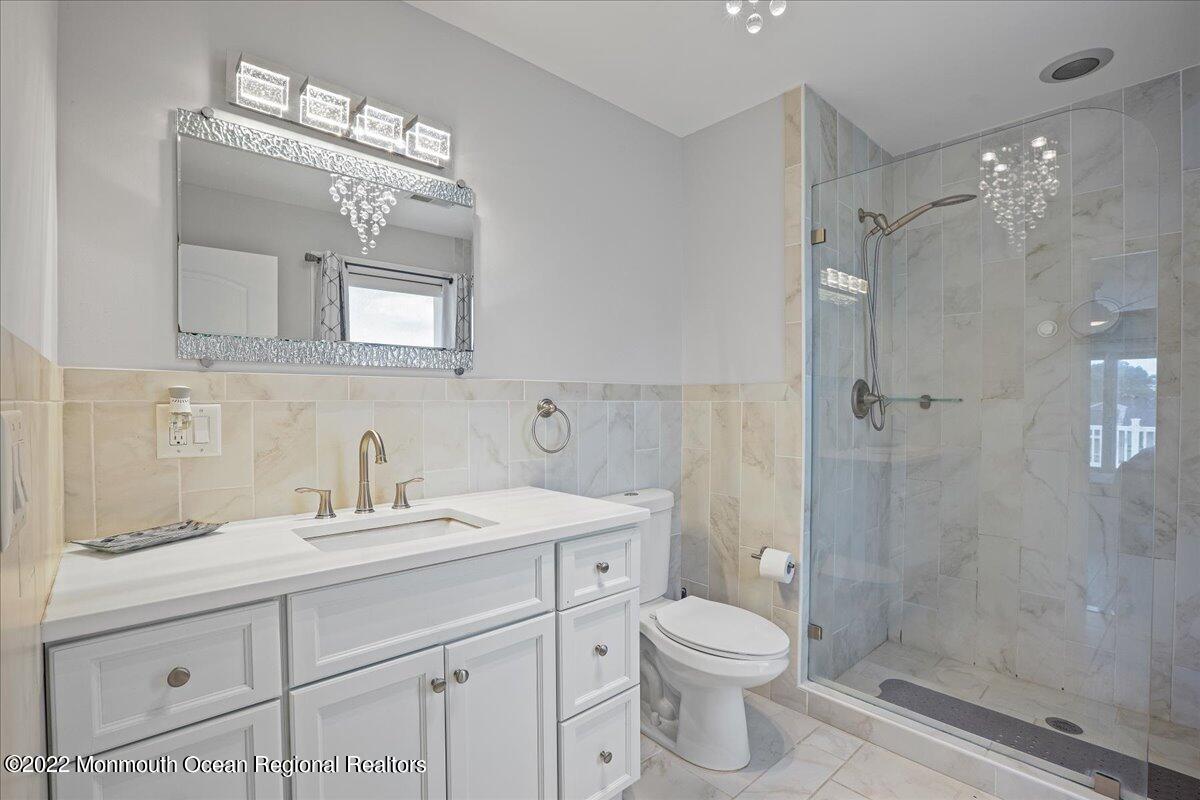 35 Channel Road Toms River, NJ 08753 - Photo 19 of 41 a bathroom with a double vanity sink mirror and shower