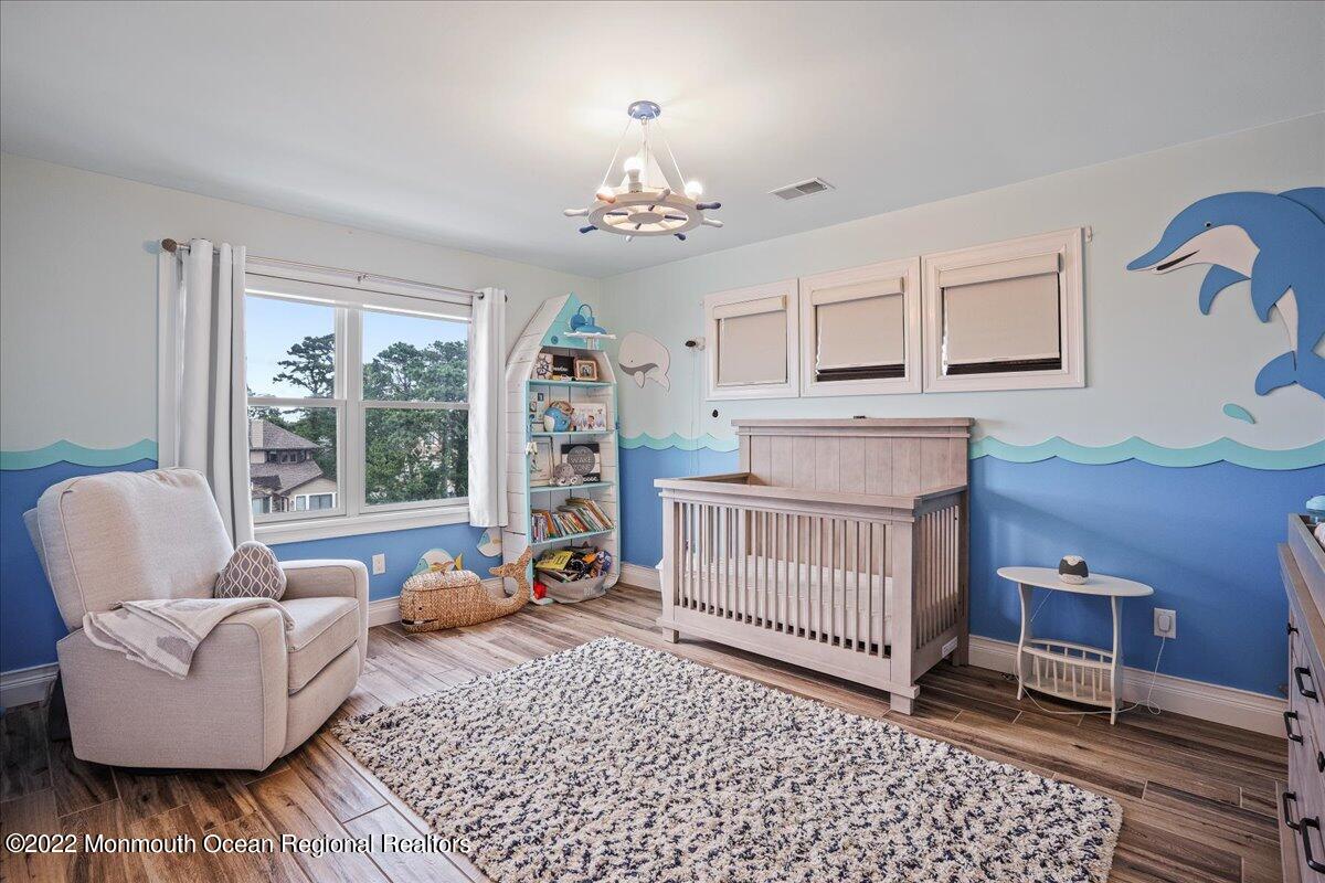 35 Channel Road Toms River, NJ 08753 - Photo 20 of 41 a living room with furniture and a baby crib