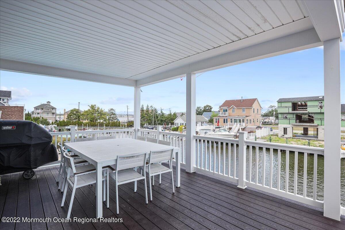 35 Channel Road Toms River, NJ 08753 - Photo 31 of 41 a view of a roof deck with table and chairs