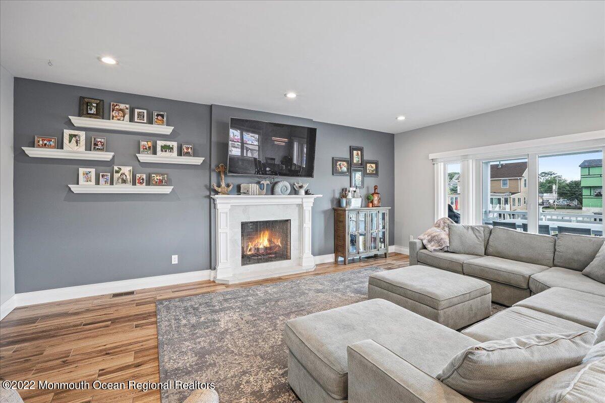 35 Channel Road Toms River, NJ 08753 - Photo 4 of 41 a living room with furniture and a fireplace