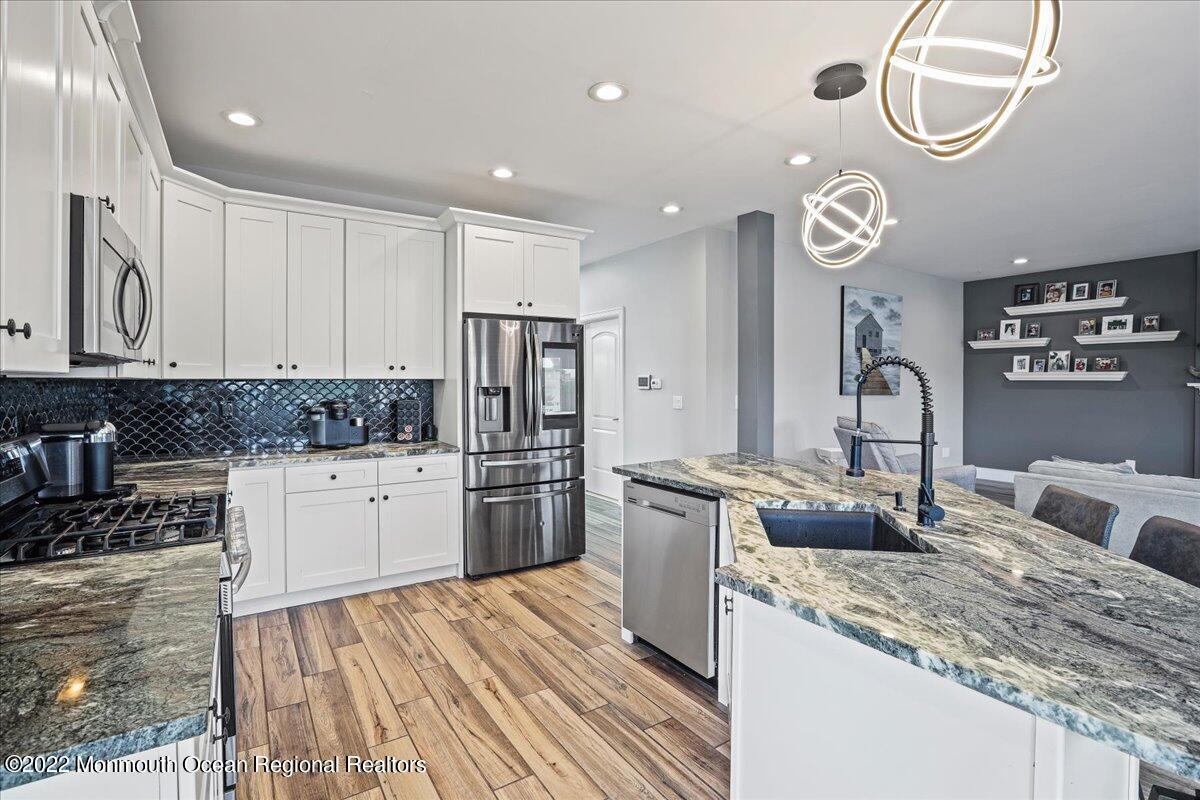 35 Channel Road Toms River, NJ 08753 - Photo 8 of 41 a kitchen with stainless steel appliances granite countertop a sink stove and refrigerator