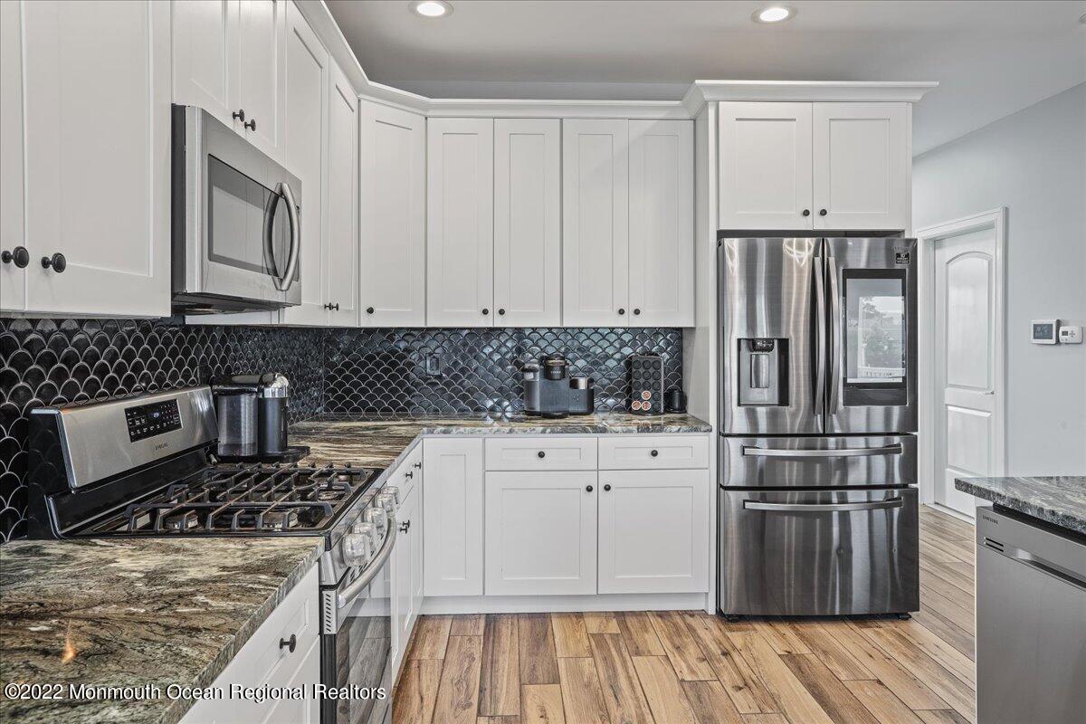 35 Channel Road Toms River, NJ 08753 - Photo 9 of 41 a kitchen with granite countertop a stove and a refrigerator