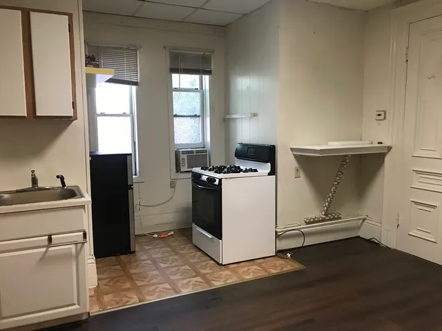 a kitchen with cabinets and window