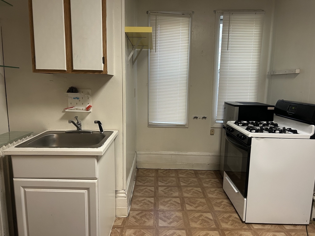 14 Monument Square, Unit 2 Boston, MA 02129 - Photo 2 of 5 a kitchen with a sink a stove and cabinets