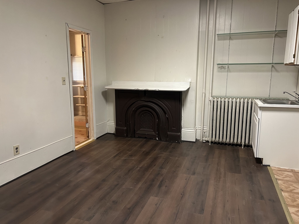 14 Monument Square, Unit 2 Boston, MA 02129 - Photo 3 of 5 a view of empty room with wooden floor and fan