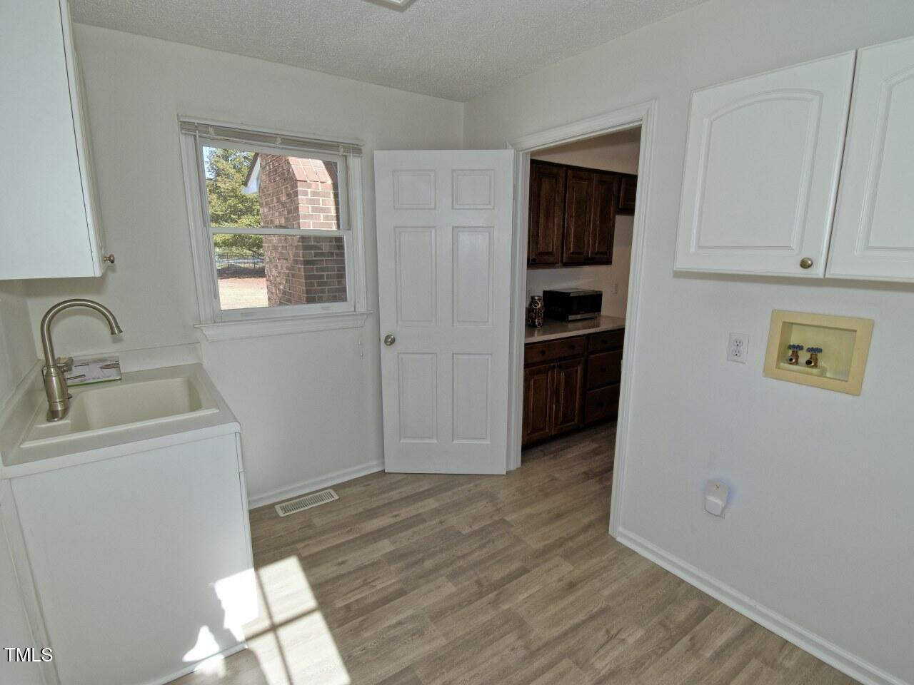 3217 Banks Road Raleigh, NC 27603 - Photo 12 of 29 a view of a kitchen that shows a sink dishwasher and a microwave oven