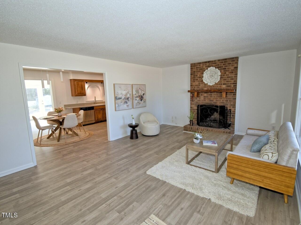 3217 Banks Road Raleigh, NC 27603 - Photo 3 of 29 a living room with furniture and a fireplace