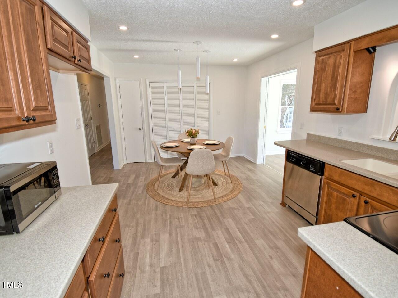 3217 Banks Road Raleigh, NC 27603 - Photo 10 of 29 a kitchen with sink cabinets and wooden floor