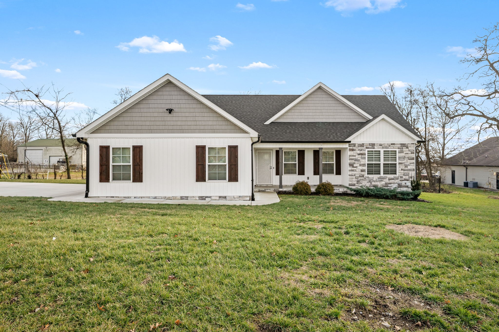 104 Rolling Road Shelbyville, TN 37160 - Photo 1 of 44 a front view of a house with a garden