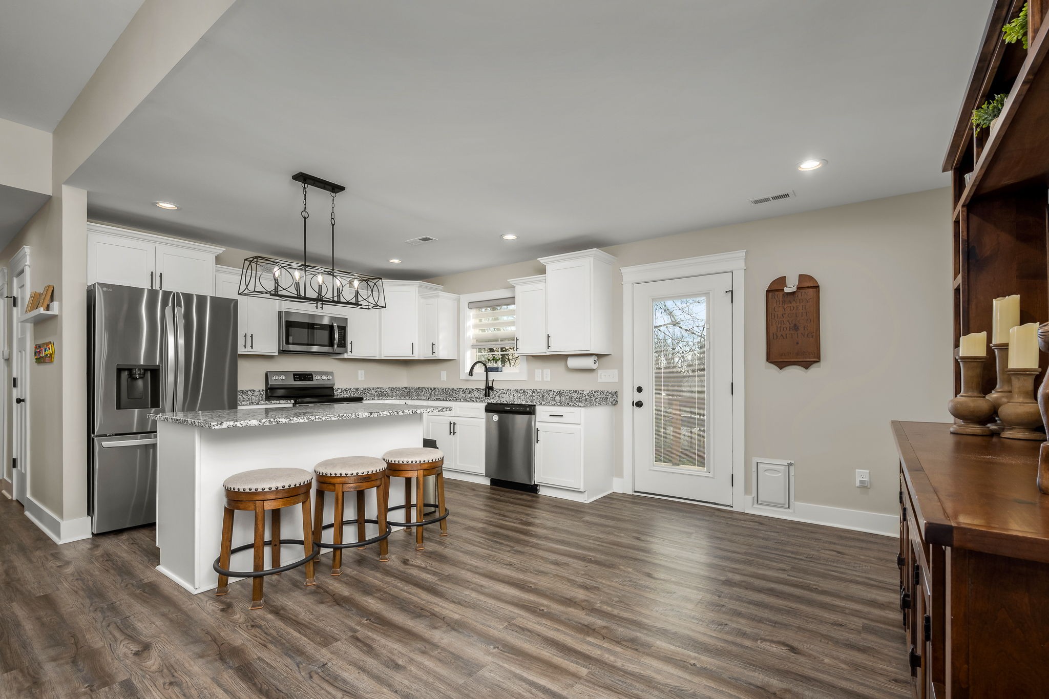 104 Rolling Road Shelbyville, TN 37160 - Photo 14 of 44 a kitchen with stainless steel appliances granite countertop a refrigerator a stove top oven a sink dishwasher and white cabinets with wooden floor