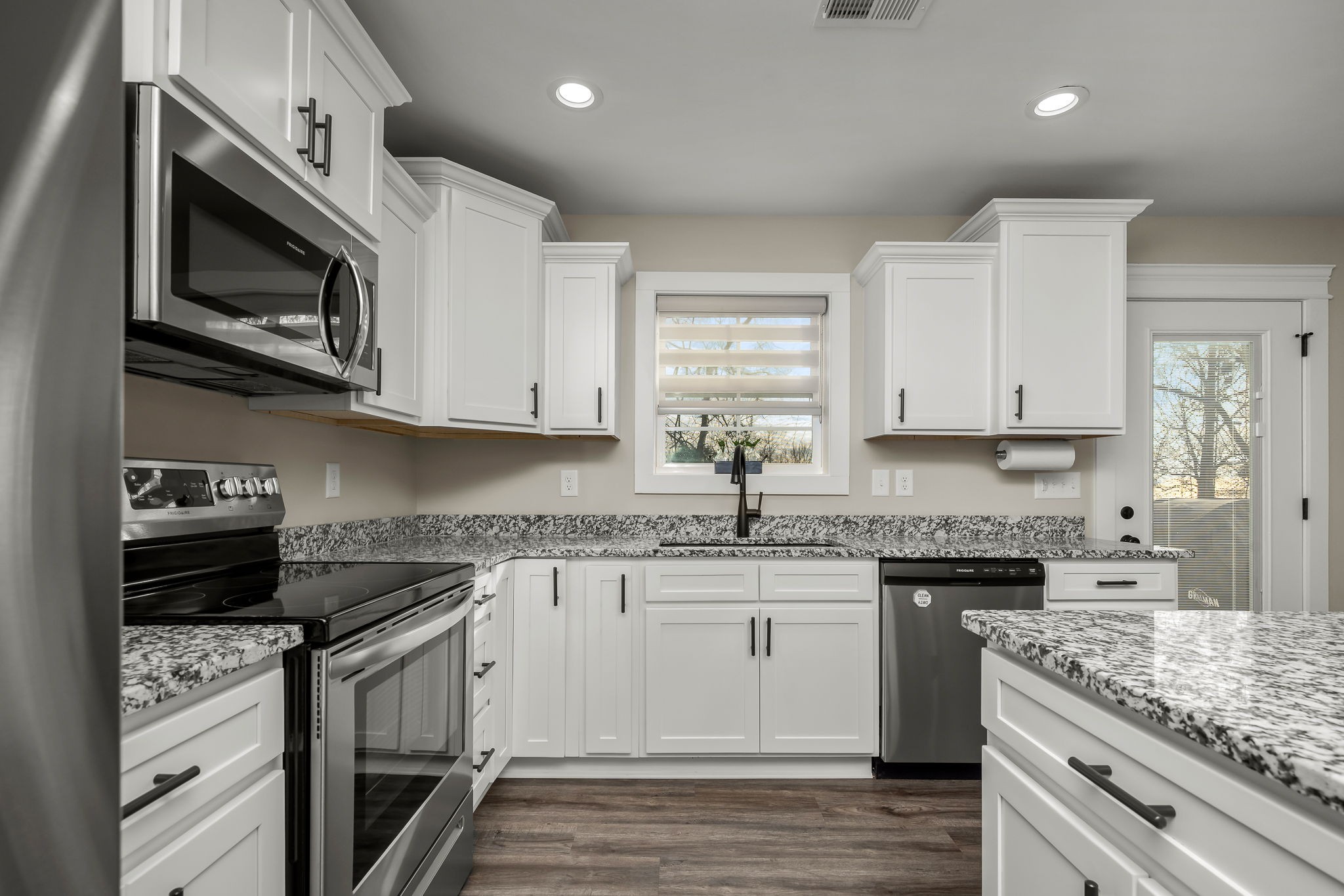 104 Rolling Road Shelbyville, TN 37160 - Photo 16 of 44 a kitchen with stainless steel appliances granite countertop a stove top oven microwave and cabinets