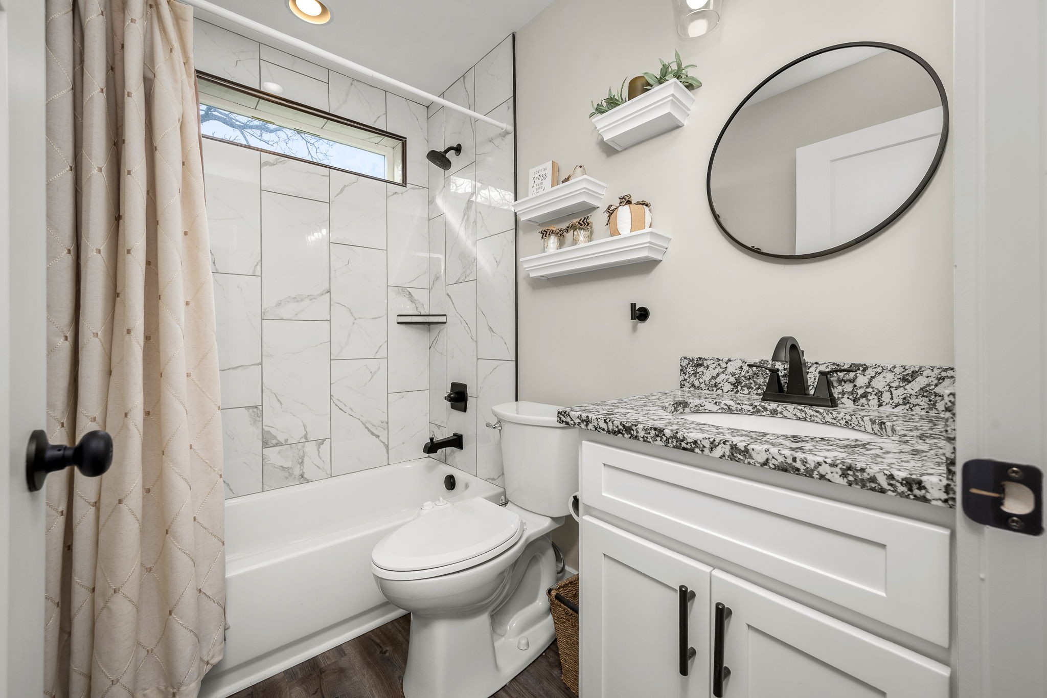 104 Rolling Road Shelbyville, TN 37160 - Photo 27 of 44 a bathroom with a granite countertop sink a toilet and a mirror