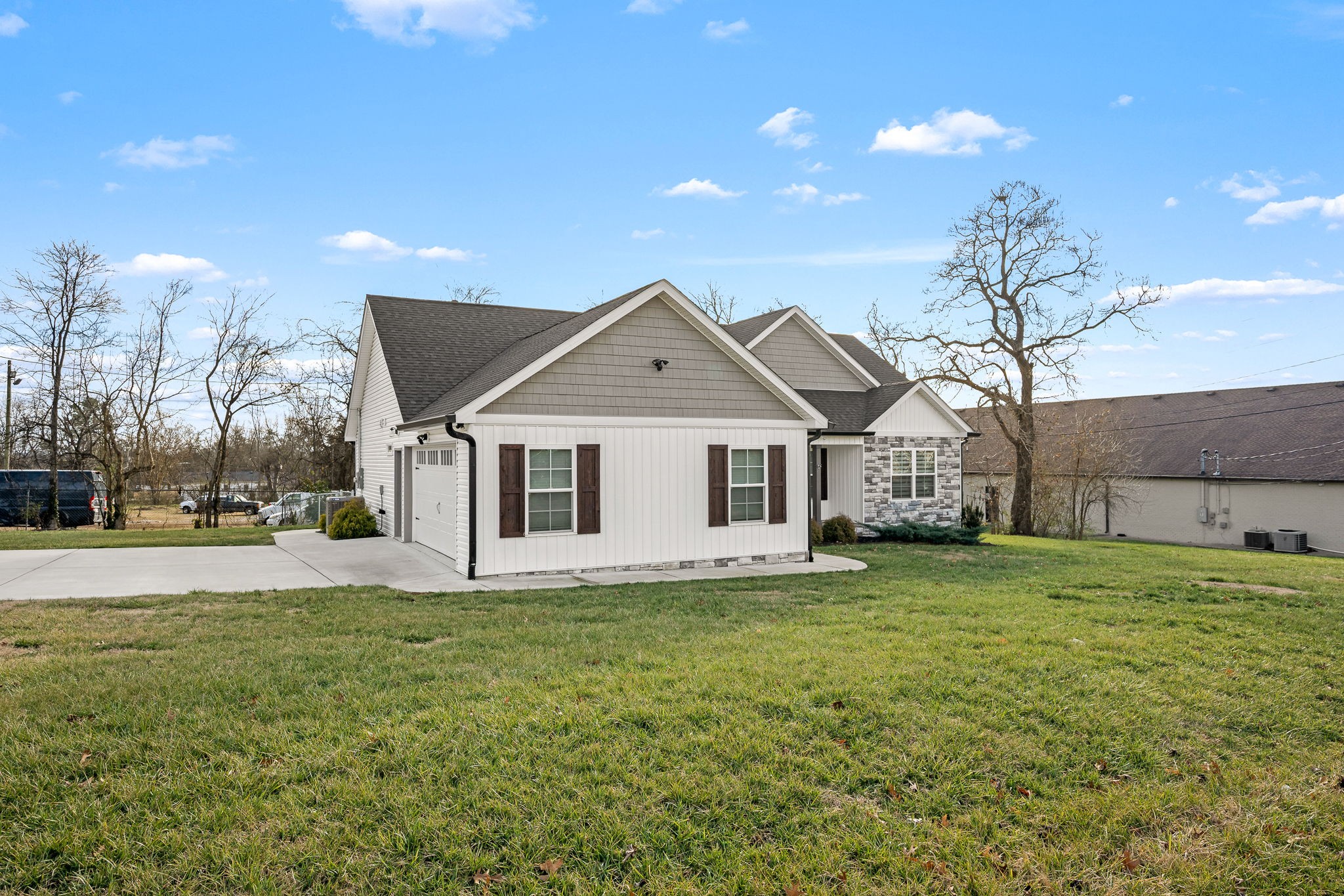 104 Rolling Road Shelbyville, TN 37160 - Photo 39 of 44 a front view of a house with a garden and yard