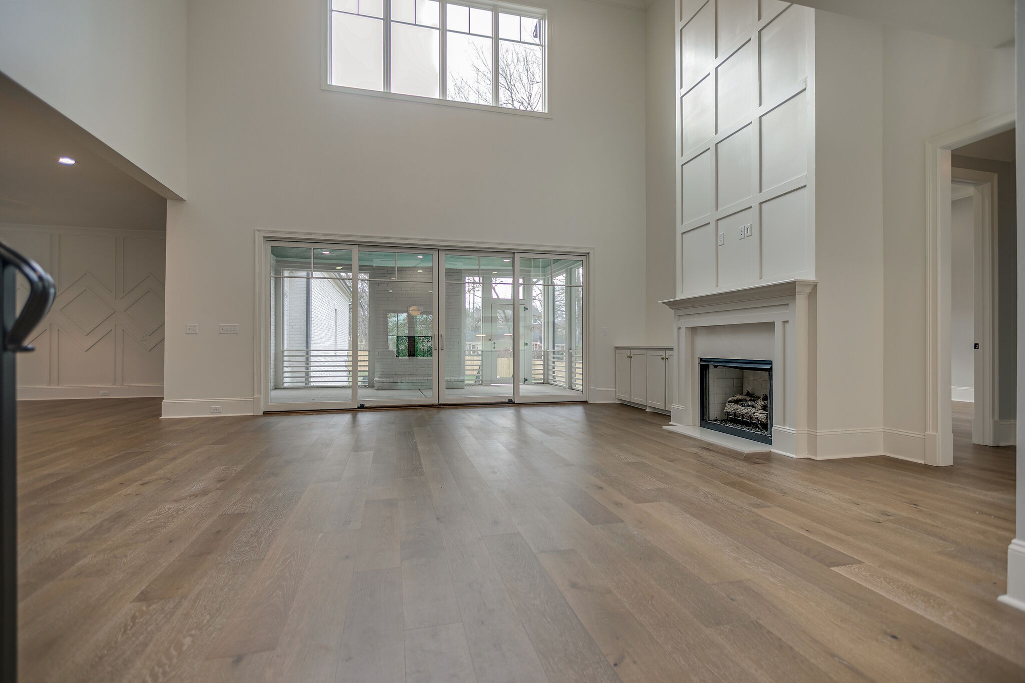 4101 Sneed Road Nashville, TN 37215 - Photo 13 of 63 an empty room with wooden floor fireplace and windows