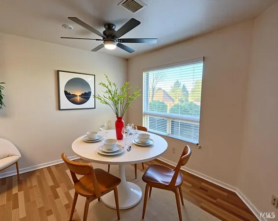 a dining room with furniture and window