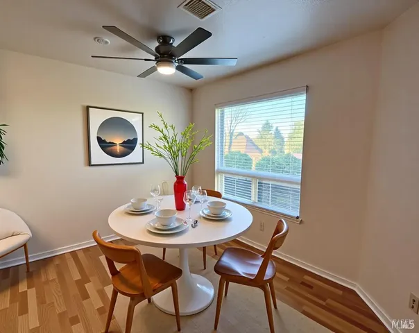 a dining room with furniture and window