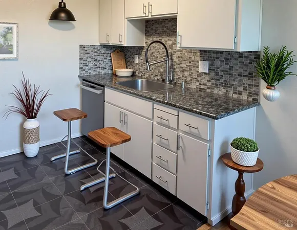 a kitchen with a sink and a stove