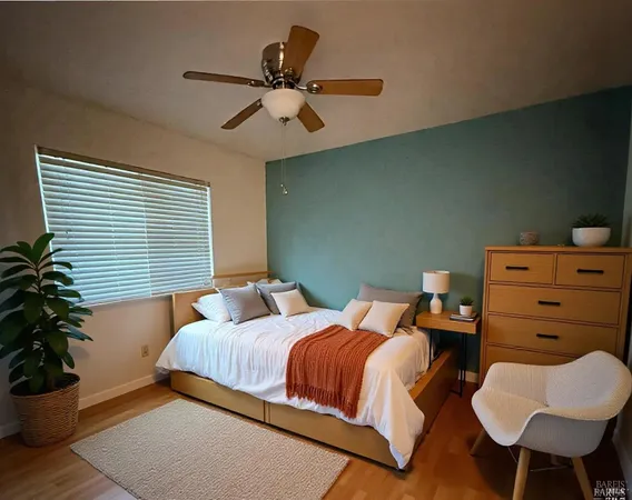 a bedroom with two beds and potted plant