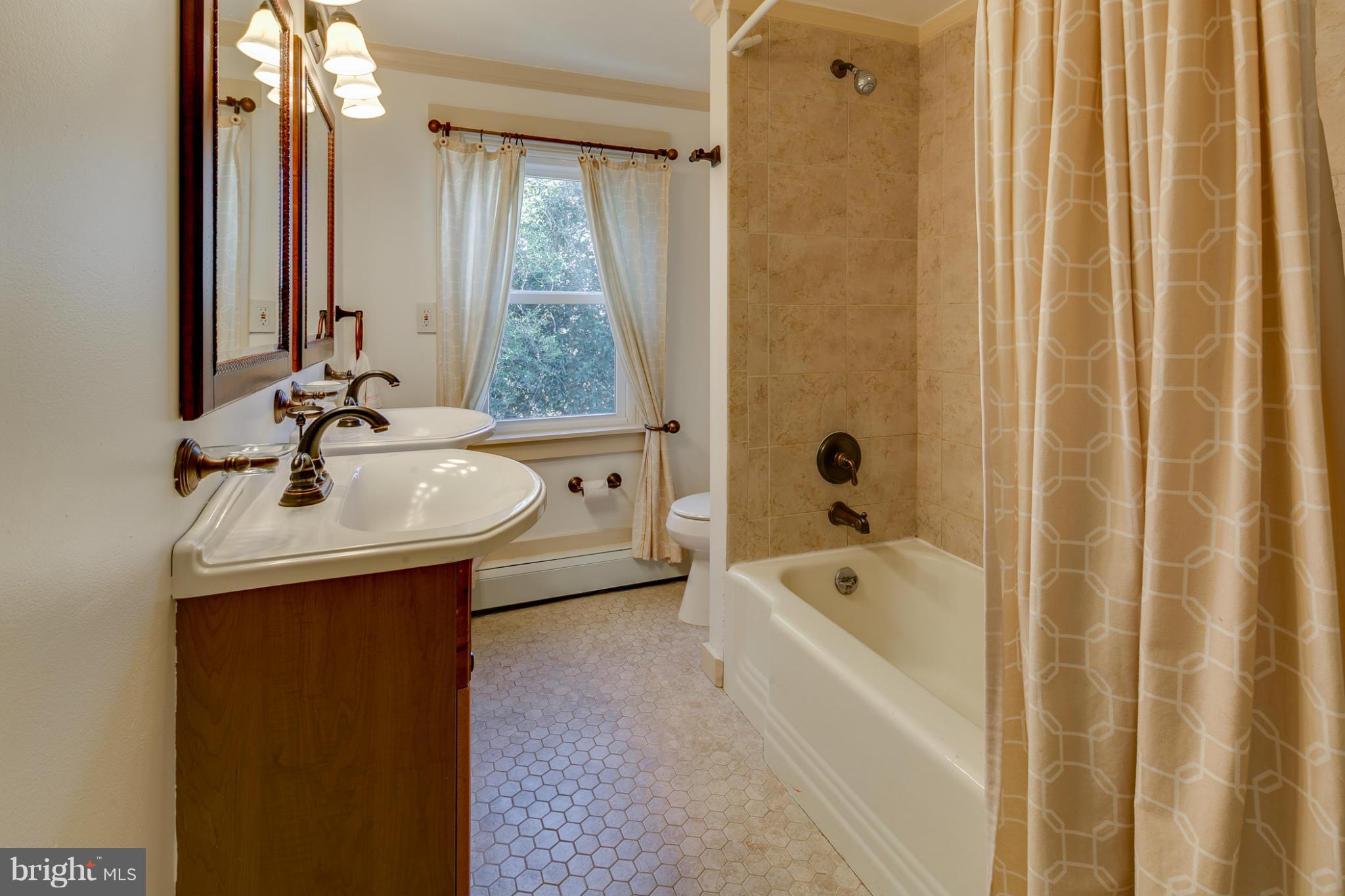 5324 Sweet Air Road Baldwin, MD 21013 - Photo 20 of 30 a bathroom with a sink a mirror and a bathtub