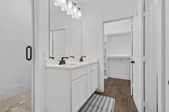 a bathroom with a double vanity sink and mirror