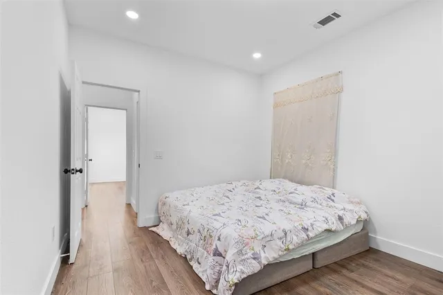 a bedroom with a bed and a mirror