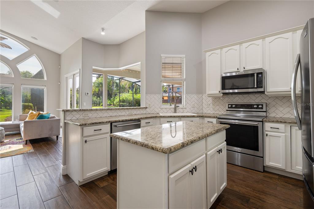 2002 Water Key Drive Windermere, FL 34786 - Photo 15 of 60 a kitchen with stainless steel appliances granite countertop a sink stove and refrigerator