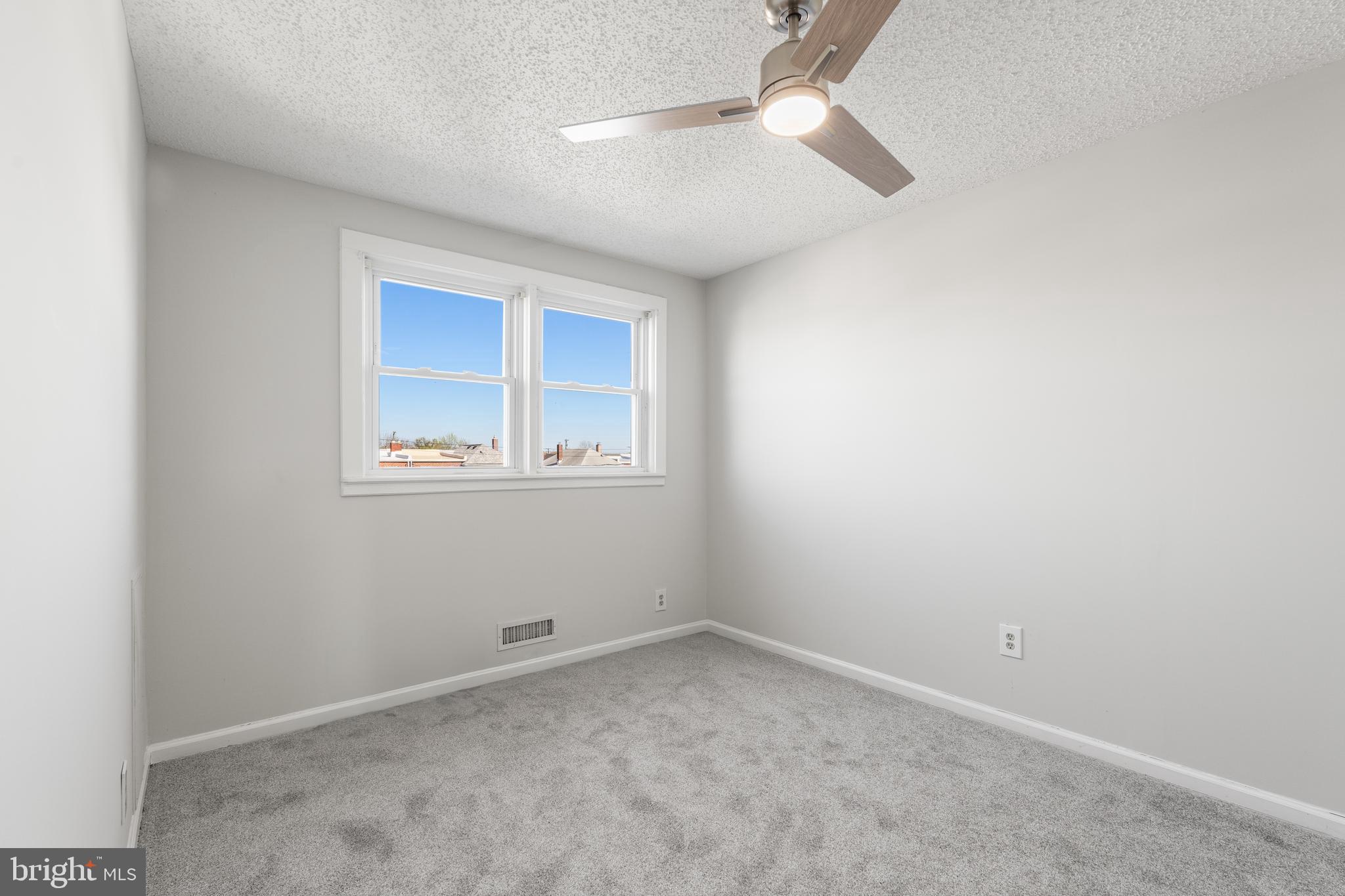 2727 Creston Road Baltimore, MD 21222 - Photo 13 of 30 an empty room with a ceiling fan and a window