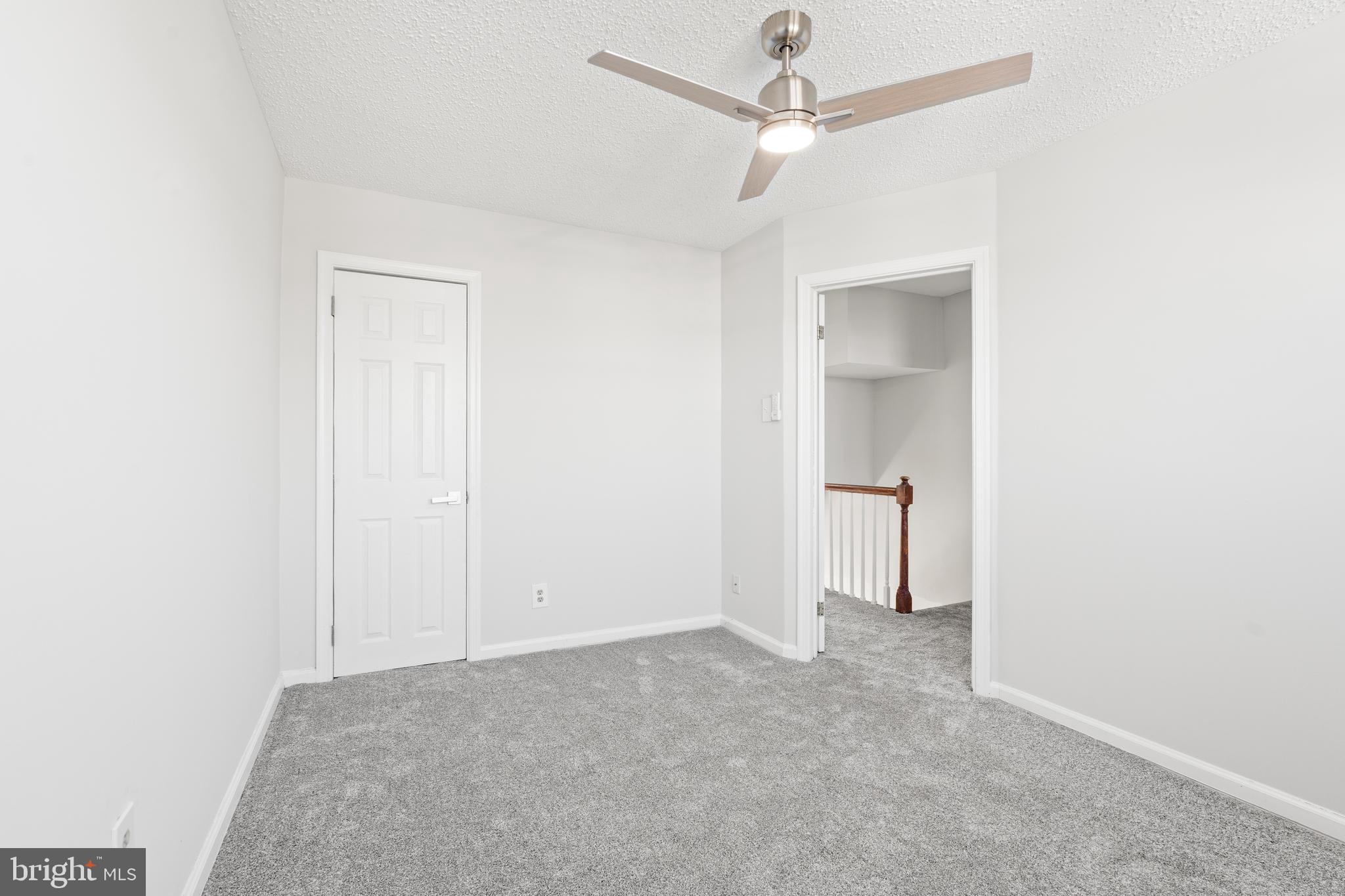 2727 Creston Road Baltimore, MD 21222 - Photo 15 of 30 an empty room with a ceiling fan and a window