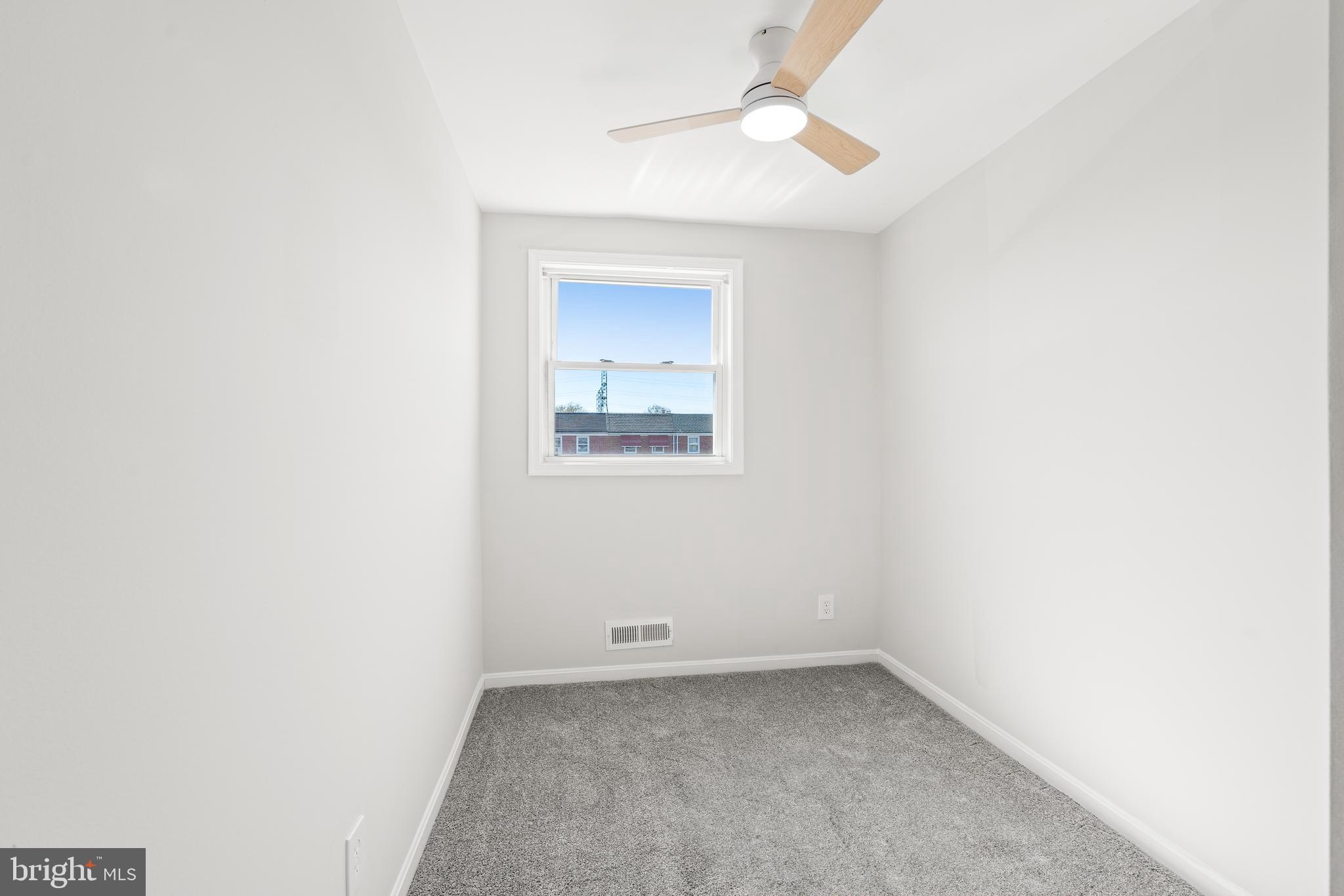 2727 Creston Road Baltimore, MD 21222 - Photo 17 of 30 an empty room with a window and a fan