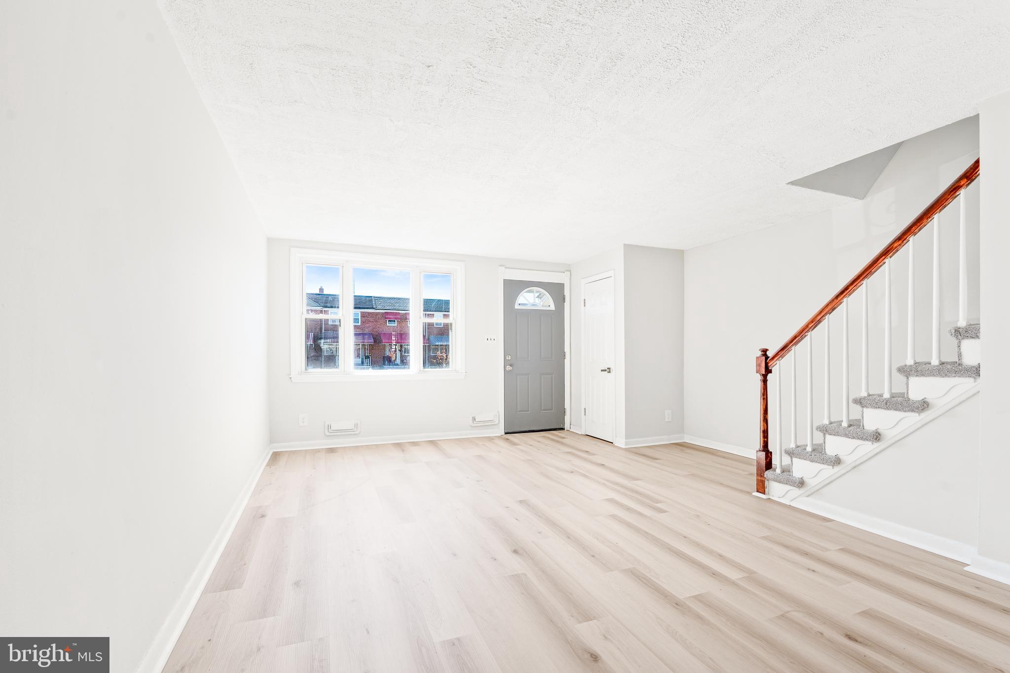 2727 Creston Road Baltimore, MD 21222 - Photo 4 of 30 a view of an empty room with wooden floor and a window