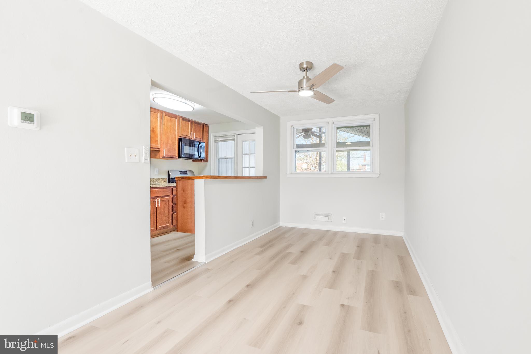 2727 Creston Road Baltimore, MD 21222 - Photo 5 of 30 a view of a kitchen with wooden floor and windows