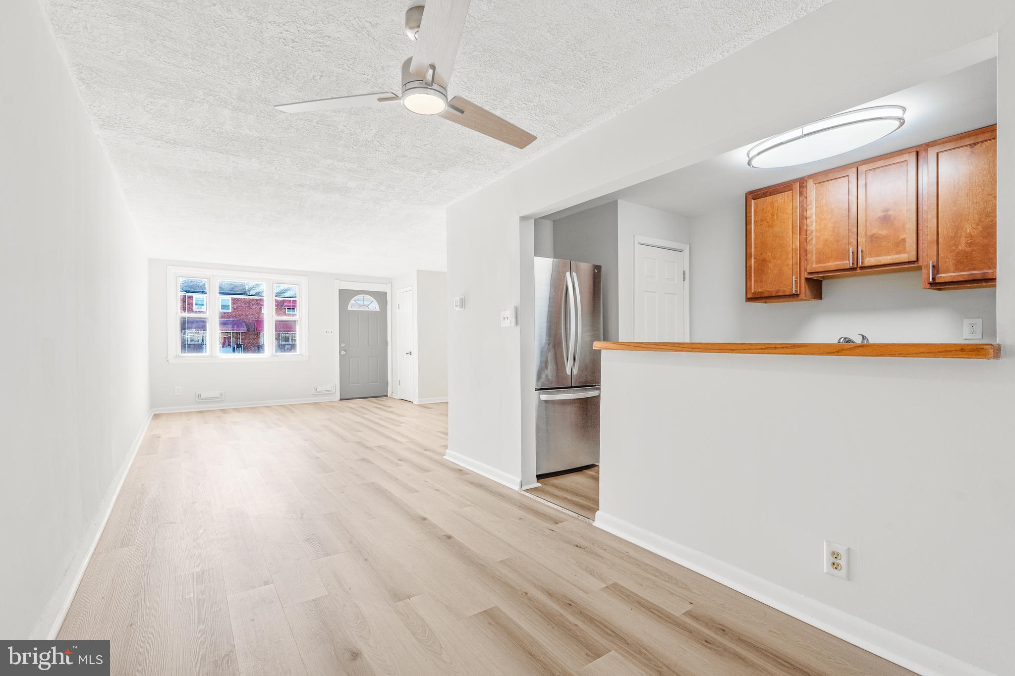 2727 Creston Road Baltimore, MD 21222 - Photo 6 of 30 a view of a refrigerator in kitchen and wooden floor