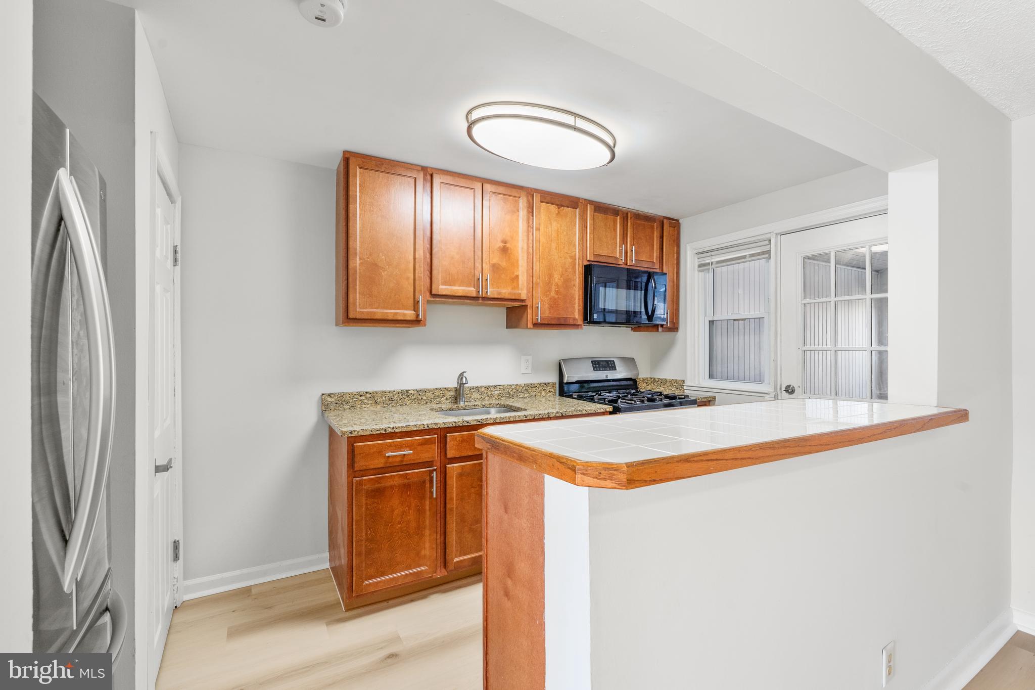 2727 Creston Road Baltimore, MD 21222 - Photo 7 of 30 a kitchen with stainless steel appliances granite countertop a sink stove and refrigerator