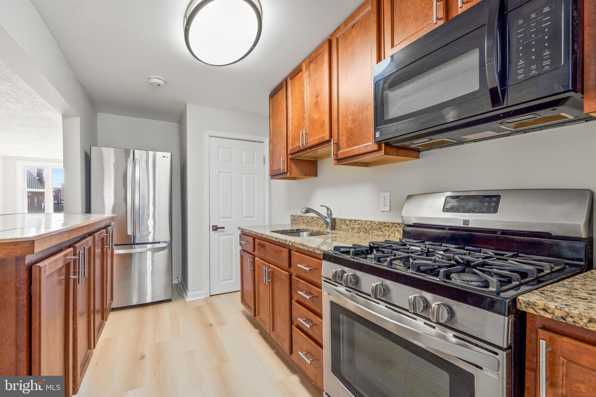2727 Creston Road Baltimore, MD 21222 - Photo 8 of 30 a kitchen with stainless steel appliances granite countertop a stove and a refrigerator