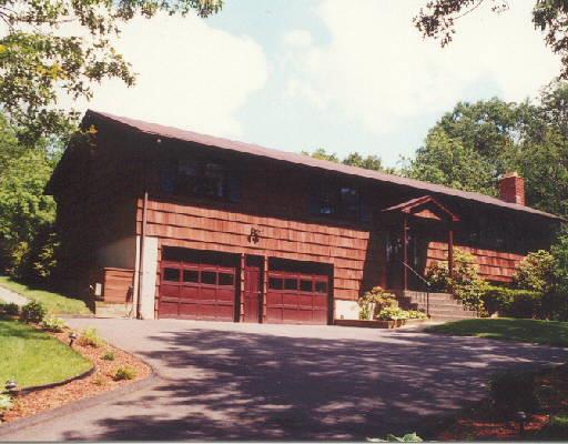 62 Bear Hills Road Newtown, CT 06470 - Photo 1 of 1 a front view of a house with a yard