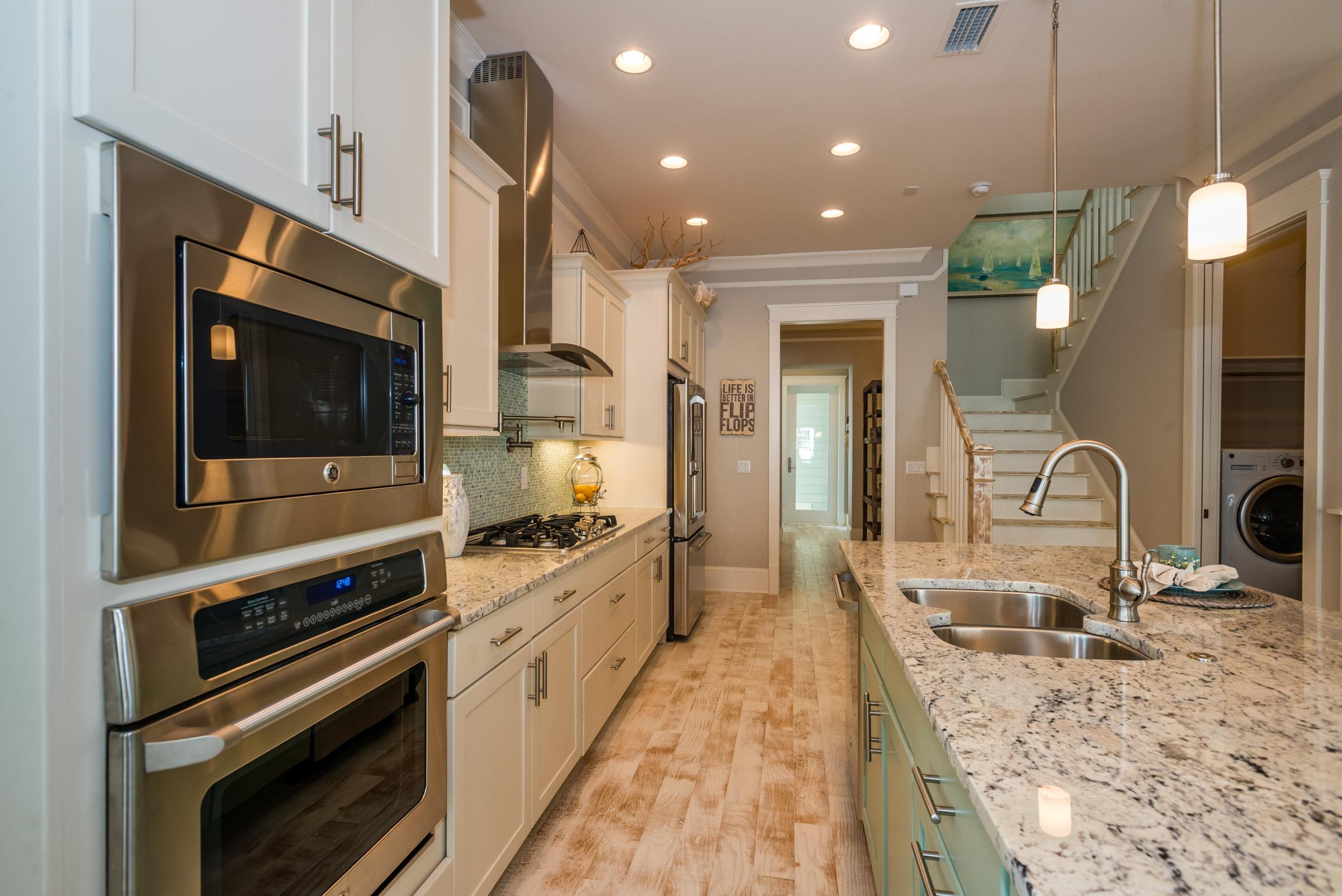 35 Prominence Inlet Beach, Unit 35 Inlet Beach, FL 32461 - Photo 12 of 43 a large kitchen with stainless steel appliances granite countertop a stove a sink and a microwave
