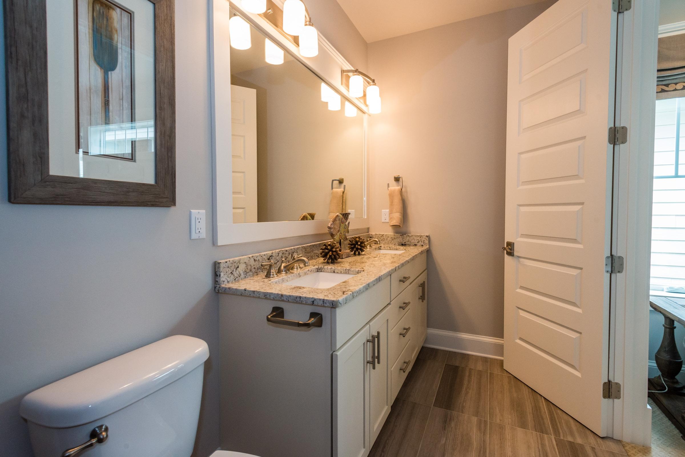 35 Prominence Inlet Beach, Unit 35 Inlet Beach, FL 32461 - Photo 34 of 43 a bathroom with a toilet sink and mirror