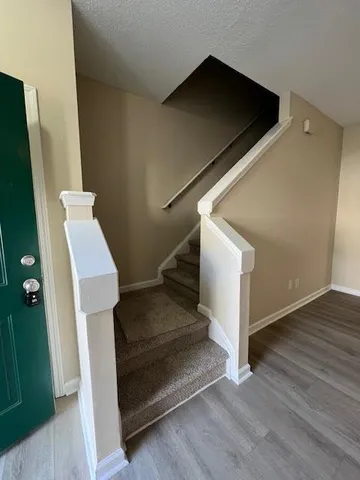 a view of entryway and hall with wooden floor
