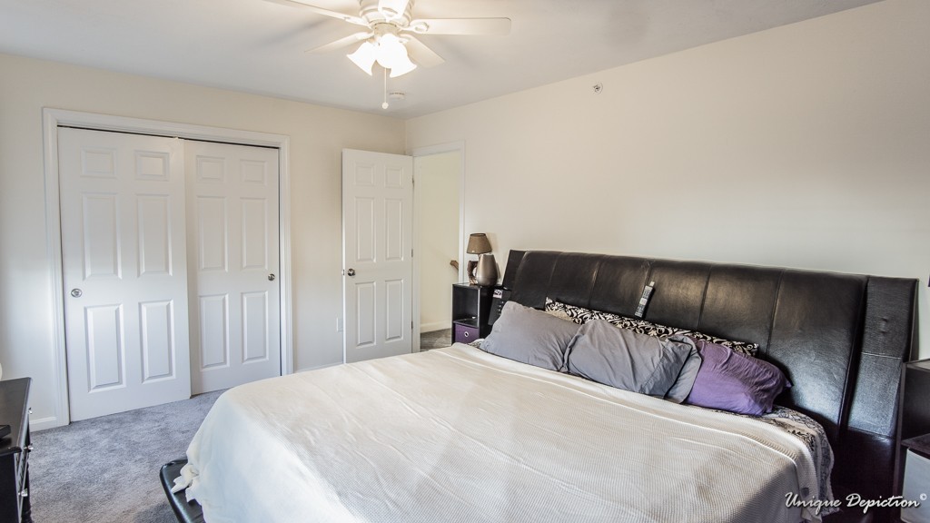 41 Boston Road, Unit 451 Billerica, MA 01862 - Photo 13 of 20 a bedroom with a large bed and a chandelier