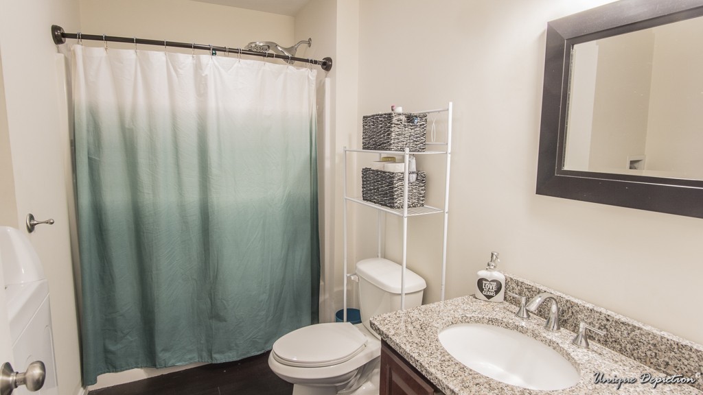 41 Boston Road, Unit 451 Billerica, MA 01862 - Photo 14 of 20 a bathroom with a sink a toilet and shower curtain