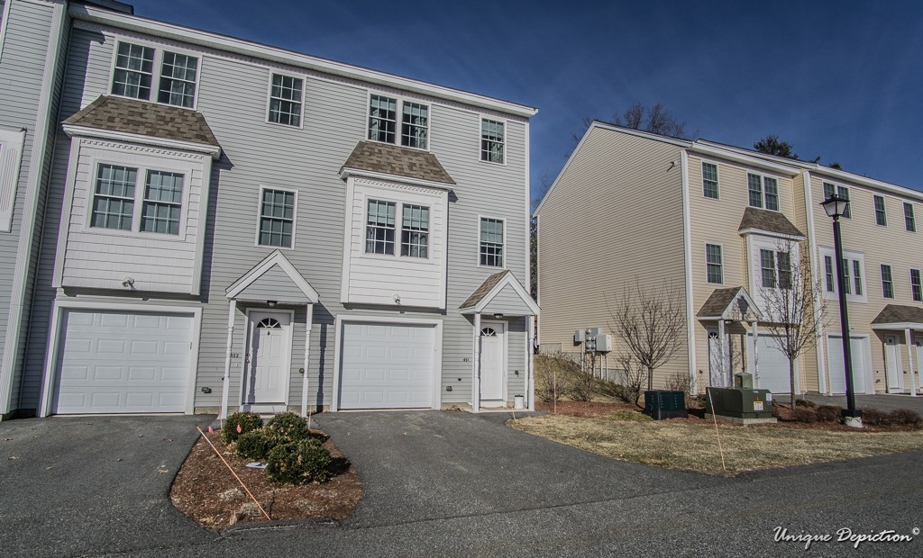 41 Boston Road, Unit 451 Billerica, MA 01862 - Photo 2 of 20 a front view of a house with a road