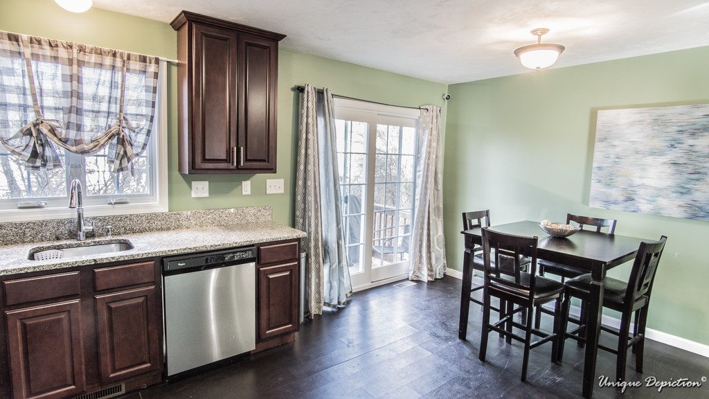 41 Boston Road, Unit 451 Billerica, MA 01862 - Photo 7 of 20 a kitchen with a table chairs and wooden floor