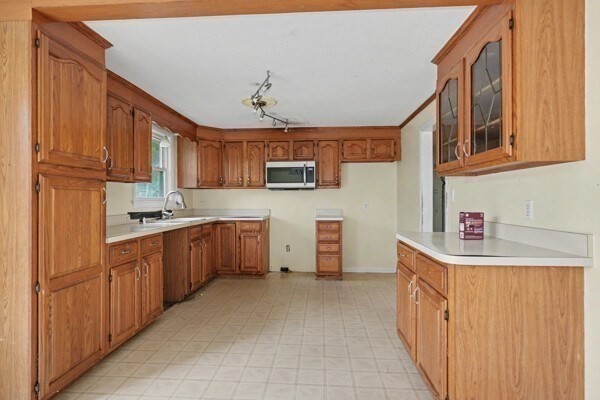 59 Donald Road Burlington, MA 01803 - Photo 11 of 12 a kitchen with stainless steel appliances granite countertop a sink and cabinets