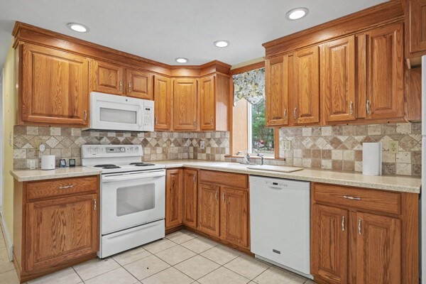 59 Donald Road Burlington, MA 01803 - Photo 6 of 12 a kitchen with white cabinets sink and white appliances