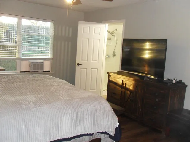 a bedroom with a bed and a flat screen tv