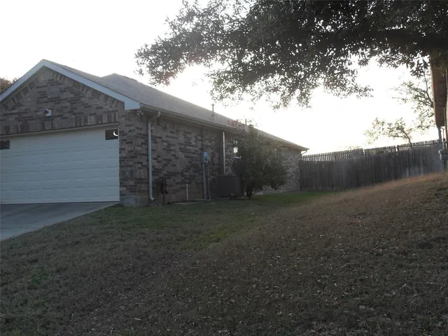a view of a backyard with large trees