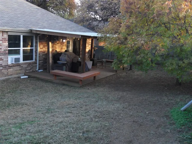 a view of a house with backyard and porch