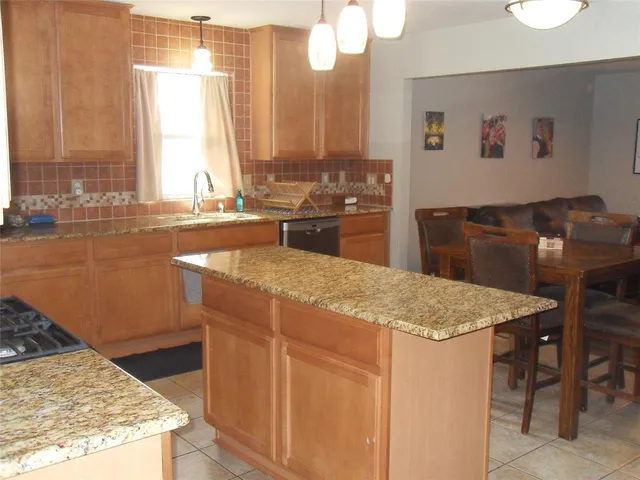 a kitchen with a stove and a refrigerator