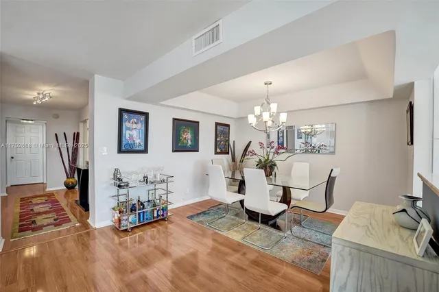 a living room with furniture a couch and paintings on the wall