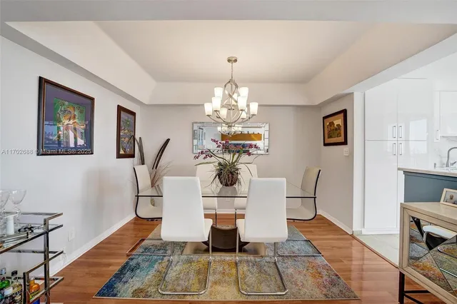 a living room with furniture a dining table and a chandelier